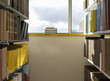 Library interior, pile of books on windowsill