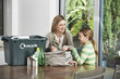 Woman and Girl Collecting Recyclables