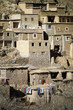 Buildings with hanging laundry on terraced slope