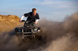 Photo: quad ATV - teenager kicking up dust quad ATV - teenager kicking up dust