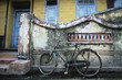 Old fashioned bicycle left by crumbling wall