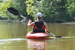 Foto: Young Woman Kayaking on the River Young Woman Kayaking on the River