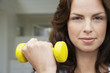 Woman lifting weight, head and shoulders