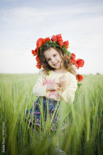 Photo: Smiling little girl in floral wreath Smiling little girl in floral wreath
