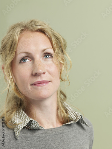 Photo: Mid adult woman looking up Mid adult woman looking up