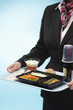 Stewardess holding tray with airplane food, mid section
