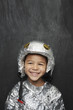 Photo: Portrait of young boy 5-6 in aluminum foil astronaut costume, smiling, studio shot Portrait of young boy 5-6 in aluminum foil astronaut costume, smiling, studio shot