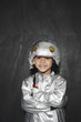 Photo: Portrait of young boy 5-6 in astronaut costume, crossed arms, smiling, studio shot Portrait of young boy 5-6 in astronaut costume, crossed arms, smiling, studio shot