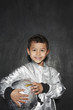 Photo: Portrait of young boy 5-6 in astronaut costume, holding helmet, smiling, studio shot Portrait of young boy 5-6 in astronaut costume, holding helmet, smiling, studio shot