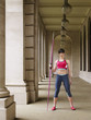 Foto: Female athlete holding javelin, standing in portico, portrait Female athlete holding javelin, standing in portico, portrait