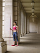 Foto: Female athlete holding javelin, standing in portico, portrait Female athlete holding javelin, standing in portico, portrait