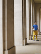 Foto: Soccer player holding ball, standing in portico, portrait Soccer player holding ball, standing in portico, portrait
