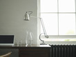 Desk with laptop, lamp and jug of water