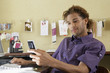 Young man using mobile phone in office
