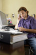 Young man using mobile phone in office