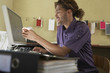 Young man pointing at computer screen in office
