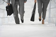 Two business people walking up stairs
