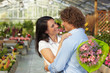 couple hugging in flower nursery