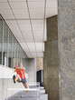 Woman jumping hurdles outside building