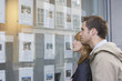 Couple looking in window outside estate agents