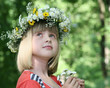 Portrait of the girl in a flower wreath.