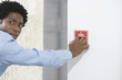 Man starting fire alarm, indoors