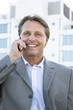 happy smiling businessman using cellphone.