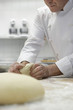 Chef preparing dough in kitchen