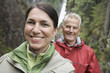 Portrait of man and woman smiling, waterfall in background