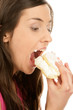 Portrait of young woman eating cake with cream
