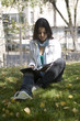 Girl student with textbook at summer day