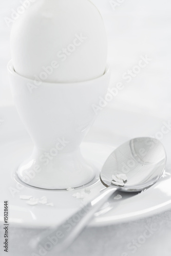 Photo: Egg in egg cup on saucer, studio shot Egg in egg cup on saucer, studio shot
