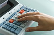 Closeup of woman's hand using calculator