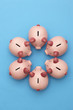 Piggy banks on blue background, view from above