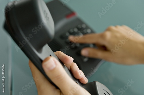 Photo: Closeup of woman's hands telephoning Closeup of woman's hands telephoning