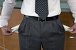 Businessman pulling out empty pockets