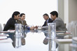 small corporate business meeting viewed along reflective surface of conference table