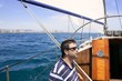 Sailor sailing blue tropical sea on sailboat