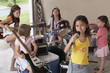 Group of girls 7-9 with instruments in garage