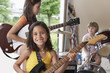 Group of girls 7-9 with instruments in garage