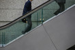 Photo: Japan, Tokyo, Tokyo International Forum, two men ascending escalator, mid section Japan, Tokyo, Tokyo International Forum, two men ascending escalator, mid section