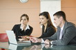Business people looking at laptop