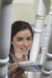 Woman painting behind banister