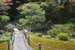 Japan, Kyoto, Tenju-an Temple garden with footpath and bridge