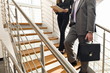 Business people on office staircase