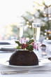 Christmas table with champagne and pudding