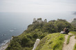 Couple Sitting on an Outlook Above the Water