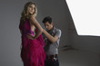 Designer Adjusting Dress Back on Fashion Model