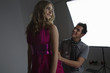 Designer Adjusting Dress Back on Fashion Model