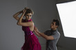 Designer Adjusting Dress Back on Fashion Model